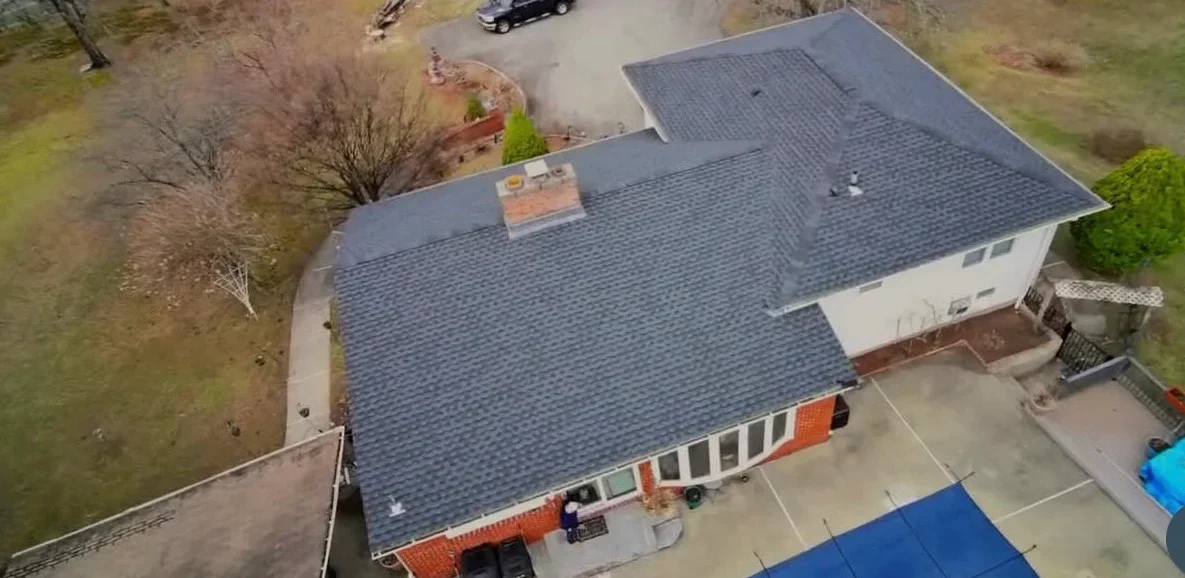 Aerial view of residential home with new slate gray dimensional shingle roof installation